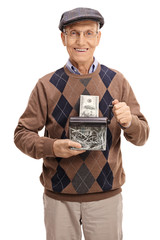 Wall Mural - Happy senior destroying a dollar bill in a paper shredder