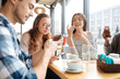 © zinkevych - Friends using smartphones in the cafe