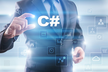 businessman selecting c# on virtual screen.