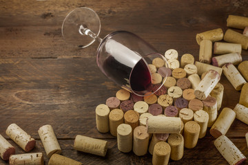 Wall Mural - Glass of red wine and corks with place for text