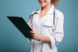 © Drobot Dean - Cropped image of a smiling young female doctor in uniform