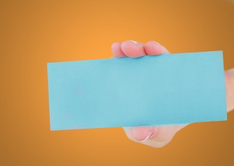 Canvas Print - Hand holding blank blue card against orange background