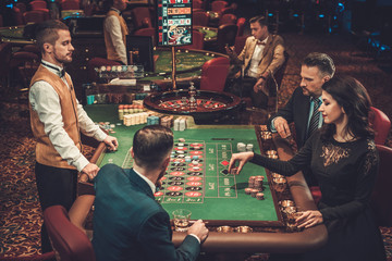 Wall Mural - Upper class friends gambling in a casino