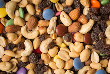Close Up Of Pile Of Trail Mix With Nuts, Raisins, And Candy