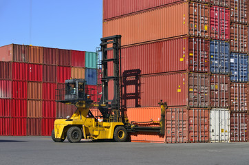 Toplifter handling cargo container loading to container trailer in import export logistic zone
