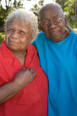 Happy mature African American sisters laughing and smiling.