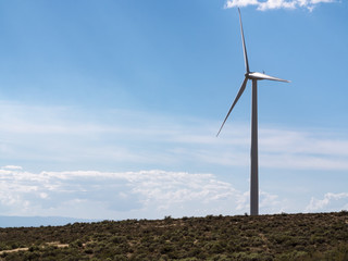 Sustainable Energy Background with Single Windmill Wind Turbine and Blue Sky