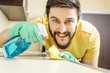 © Iurii - Male janitor cleaning kitchen with sponge
