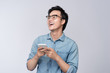 Smart casual asian man using smartphone in studio background