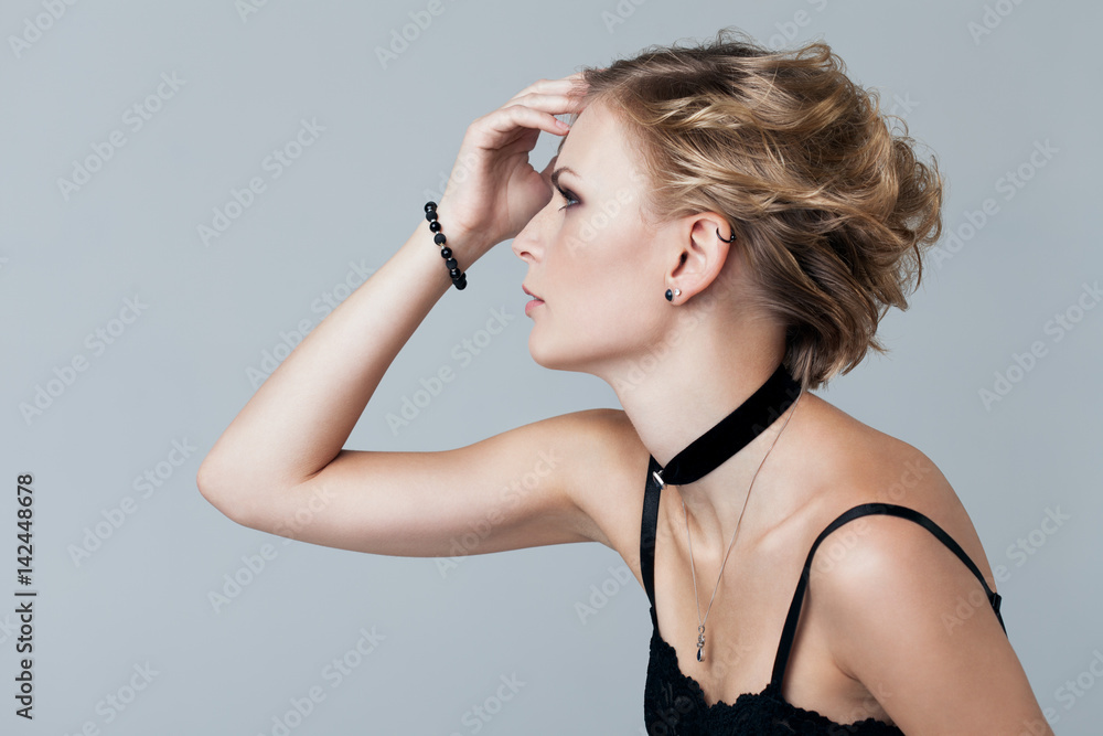 Portrait Of A Beautiful Serious Blonde Girl In A White