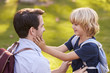 © Monkey Business - Father Fastening Son's Backpack As They Get Ready For Hike
