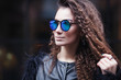 © oksana_bondar - Close-up face portrait of young beautiful woman with perfect skin in Cat's eye sunglasses in the cityscape. Beauty face make-up