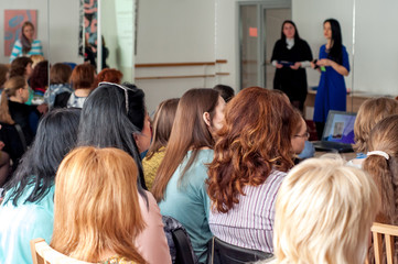 a group of girls listen to a lecture