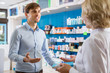 © caftor - Ordinary guy talking to pharmacist at pharmacy