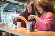 © Davide Angelini - Multiracial best friends having fun at the bar drinking tea