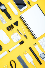 Poster - Flat lay of office supplies, digital devices and notepad on yellow