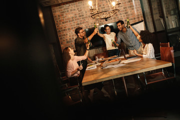 Wall Mural - Business professionals celebrating success with beers