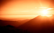 © dachux21 - A beautiful, colorful, abstract mountain landscape with sun in a red tonality. Decorative, artistic look.