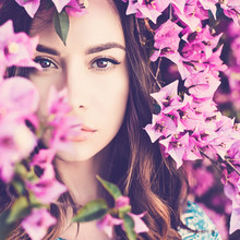Beautiful Young Woman Surrounded By Flowers