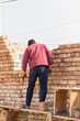 © schankz - Worker builds a brick wall in the house