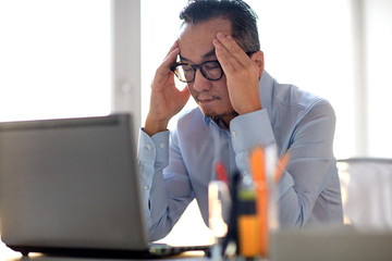 Canvas Print - businessman in eyeglasses with laptop at office