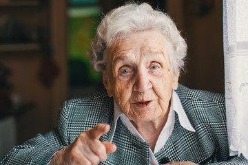 Wall Mural - Elderly woman sitting and talk in his house.