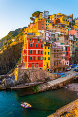 Canvas Print - Riomaggiore village lit during sunset in Cinque terre, Italy.