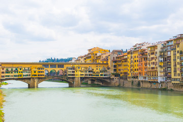 Wall Mural - Historical buildings stretched alongside river Arno in the historical center of the italian city Florence.