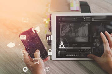 Poster - businessman working with smart phone and digital tablet computer on wooden desk in modern office with virtual icons interface