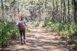 © Johnstocker - Tourist with backpack walking through in forest to go mountain top.