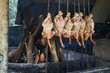 © FrontlitPhotography - Chickens cooking on metal skewers by a wood fire at a roadside stall in Pakistan