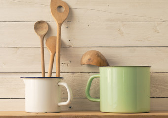 Old wooden cooking spoons on white barn wood