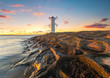 Beautiful sunset over a windmill-shaped lighthouse, Swinoujscie, Poland.