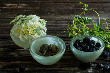 Blueberries in a glass bowl on dark table