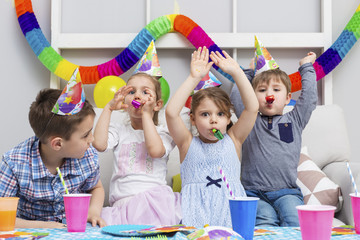 Happy group of children having fun at birthday party. Happy birthday