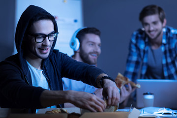 Handsome pleasant man intending to eat pizza