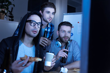 Handsome male colleagues spending time together