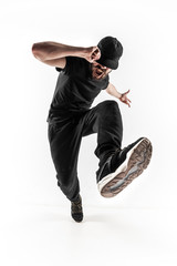 The silhouette of one hip hop male break dancer dancing on white background