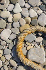 old marine rope on the pebble beach