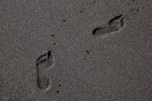 Footprints in the black sand