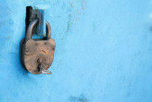 Old Rusty Lock With A Key On A Blue Background