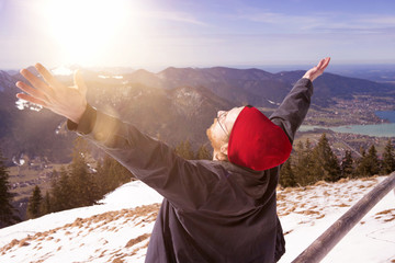 Wall Mural - young bearded man surrounded by mountains stretching his arms