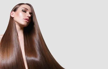 Very long, straight silky hair. The girl with long hair. Keratin straightening. Hair care.