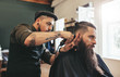 © Jacob Lund - Man getting trendy haircut in barbershop