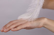 © dream@do - Attractive young woman touching her smooth perfect hand skin after beauty treatment with feather.