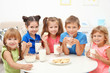 © Africa Studio - Happy children sitting at table and drinking milk