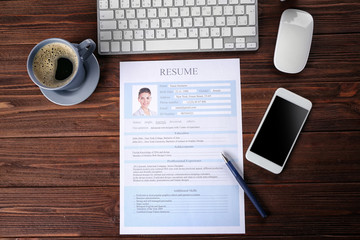 Wall Mural - Resume, phone and keyboard on wooden table