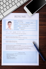 Wall Mural - Resume, phone and keyboard on wooden table