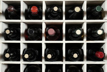 Canvas Print - Wine bottles on wooden racks in cellar