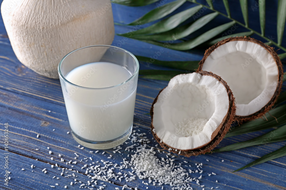 Composition with fresh coconut milk on wooden background